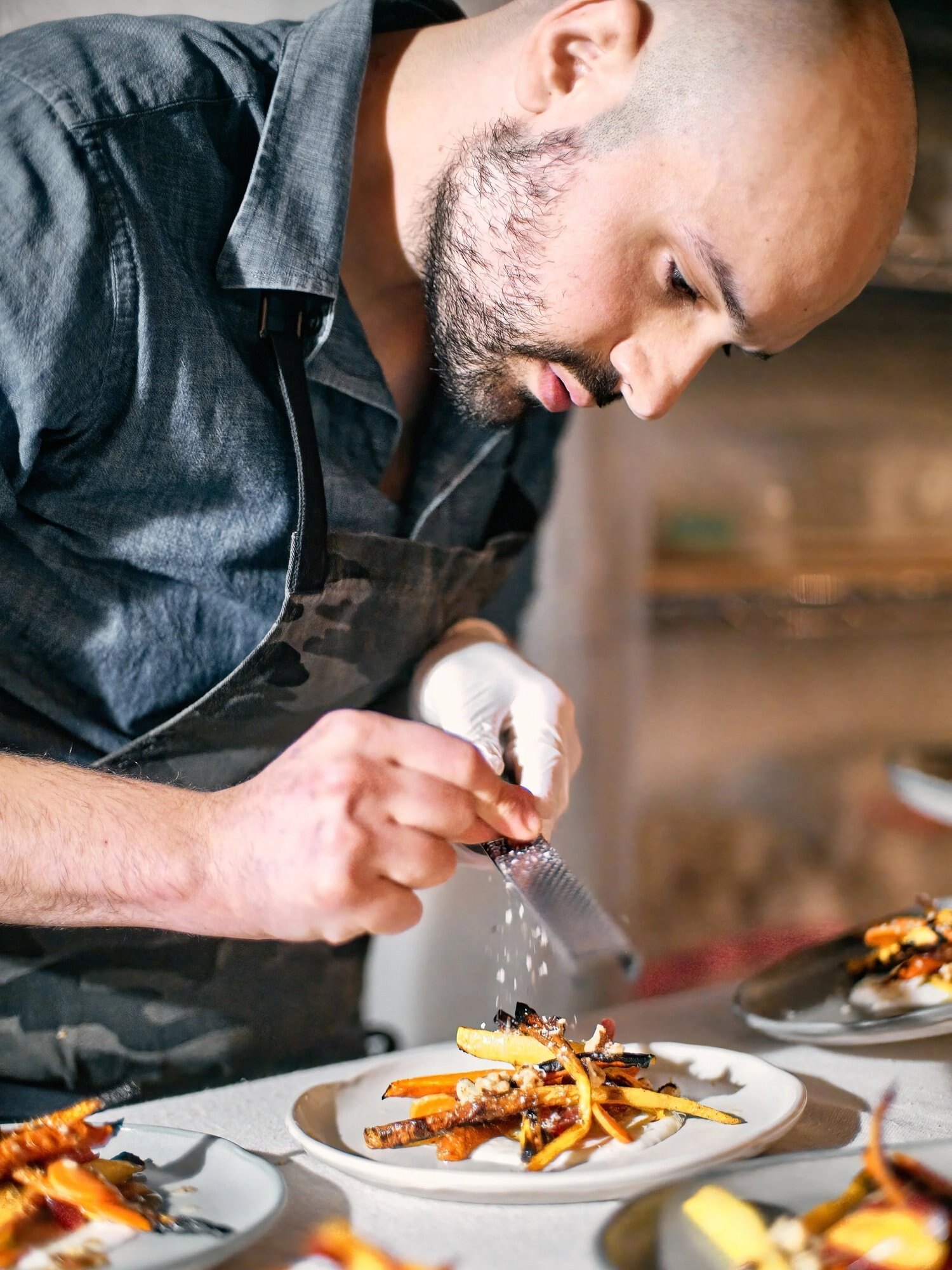 Chef finishing a plated dish in the Pinky's kitchen